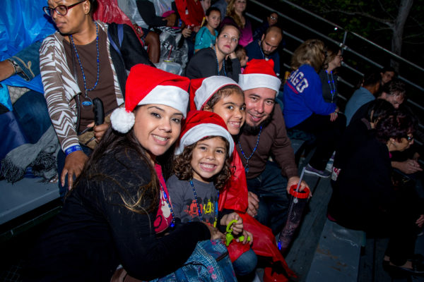 A family enjoying watching the Winterfest Boat Parade from the Parade Viewing Area