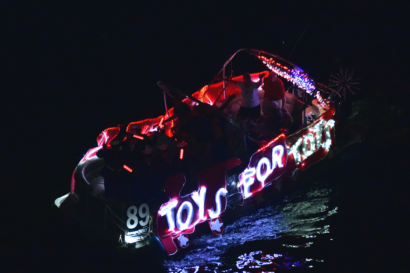 Marine Toys For Tots on board Stay Afloat Party Boat, boat number 89 in the 2021 Winterfest Boat Parade