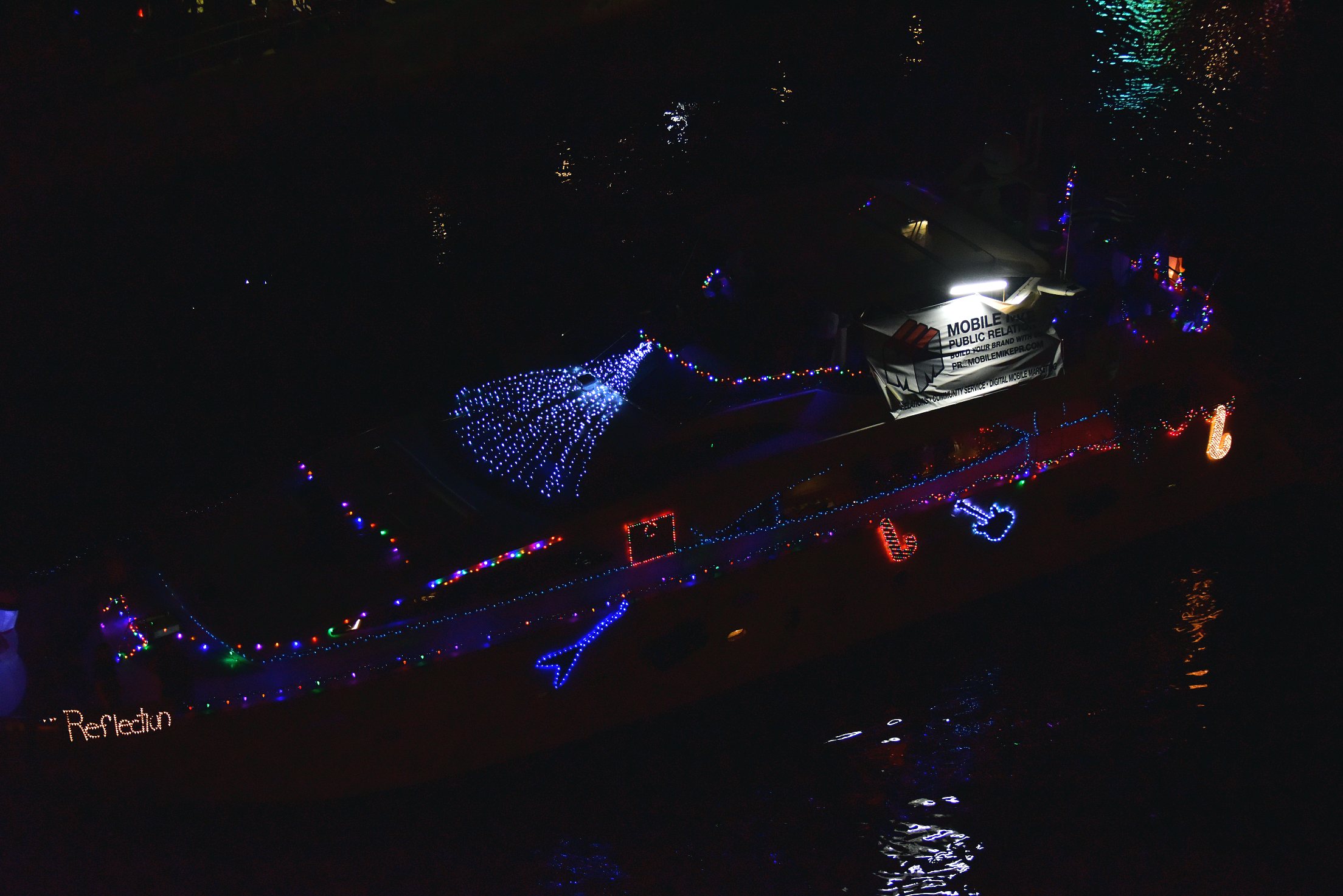 Mobile Mike on board Reflection, boat number 9 in the 2021 Winterfest Boat Parade
