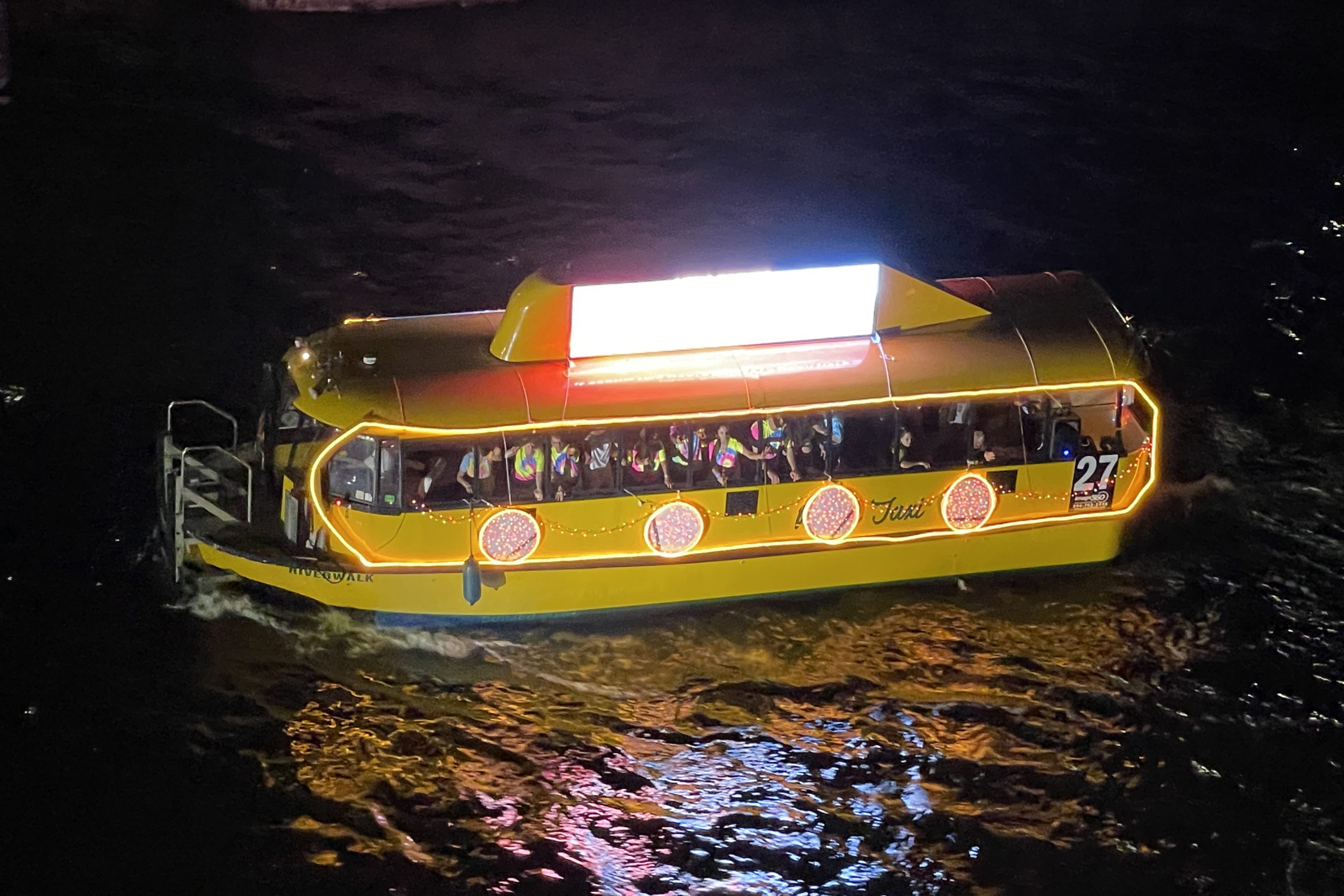 Water Taxi Riverwalk - Yellow Submarine, boat number 27 in the 2022 Winterfest Boat Parade