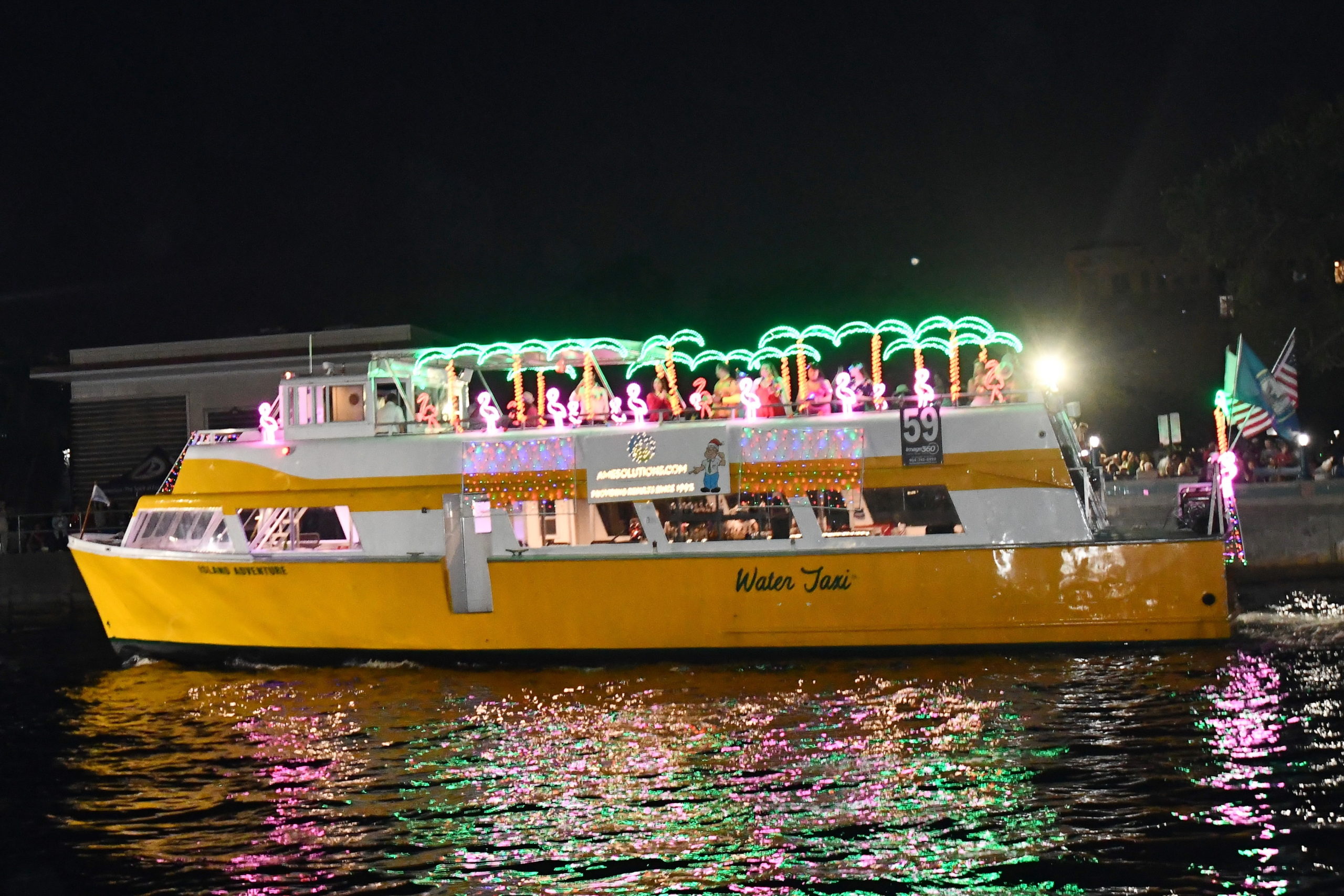 A-M-E Solutions Aboard Water Taxi Island Adventure, boat number 59 in the 2022 Winterfest Boat Parade