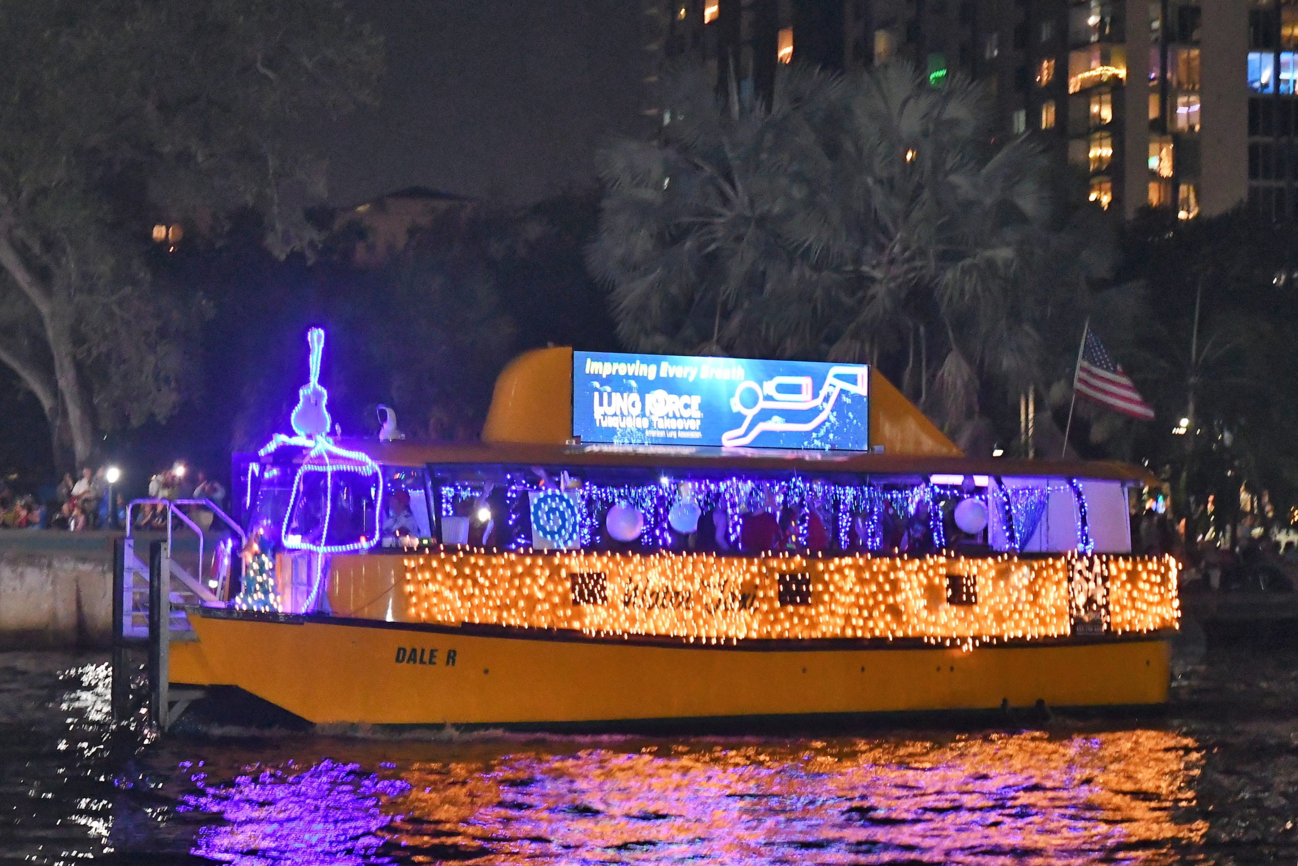 Water Taxi Dale R with ACL Turquoise Takeover, boat number 64 in the 2022 Winterfest Boat Parade