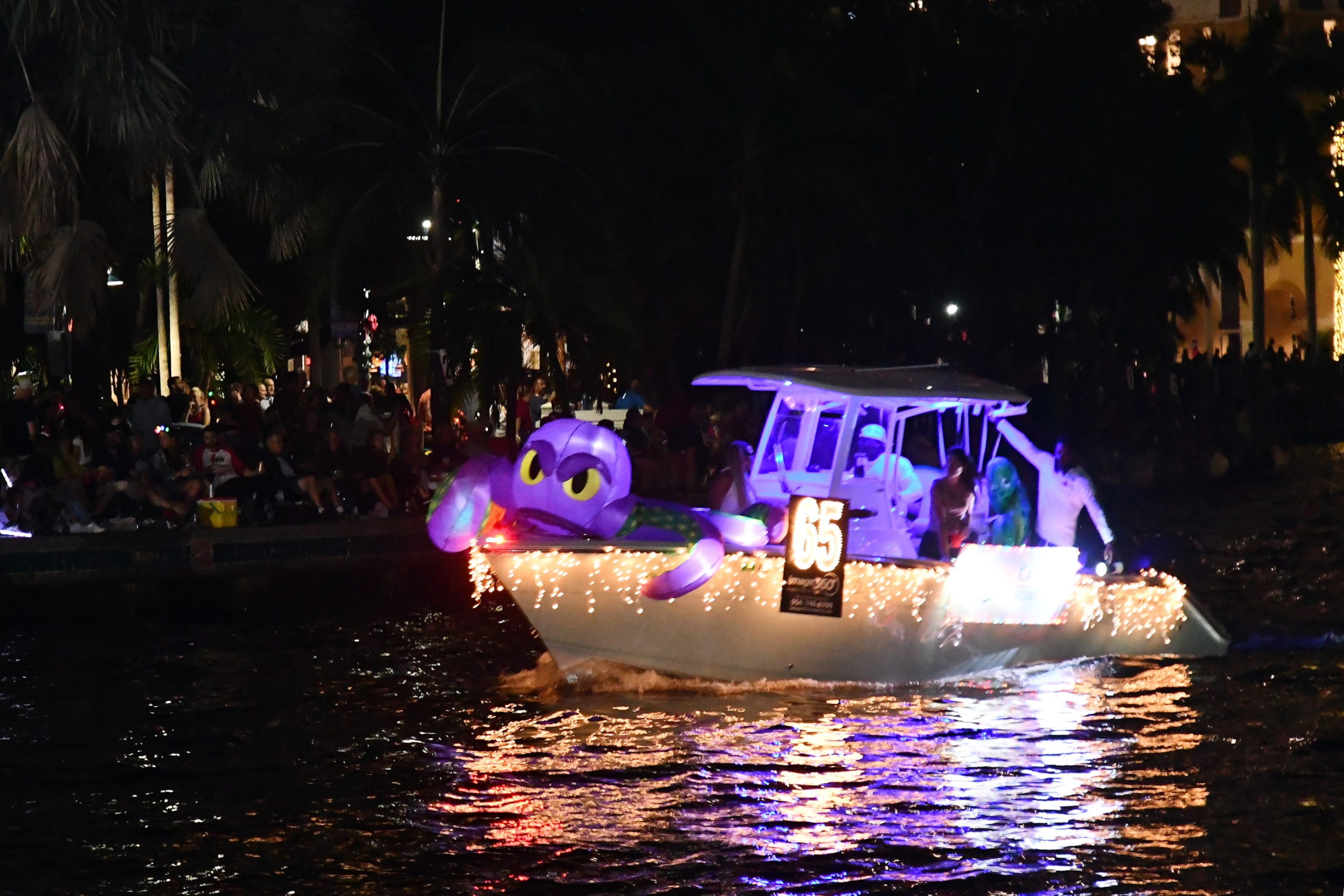 Carefree Boat Club Aboard Marlin, boat number 65 in the 2022 Winterfest Boat Parade
