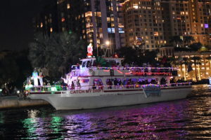 Triple Care aboard Catch My Drift, boat number 72 in the 2022 Winterfest Boat Parade