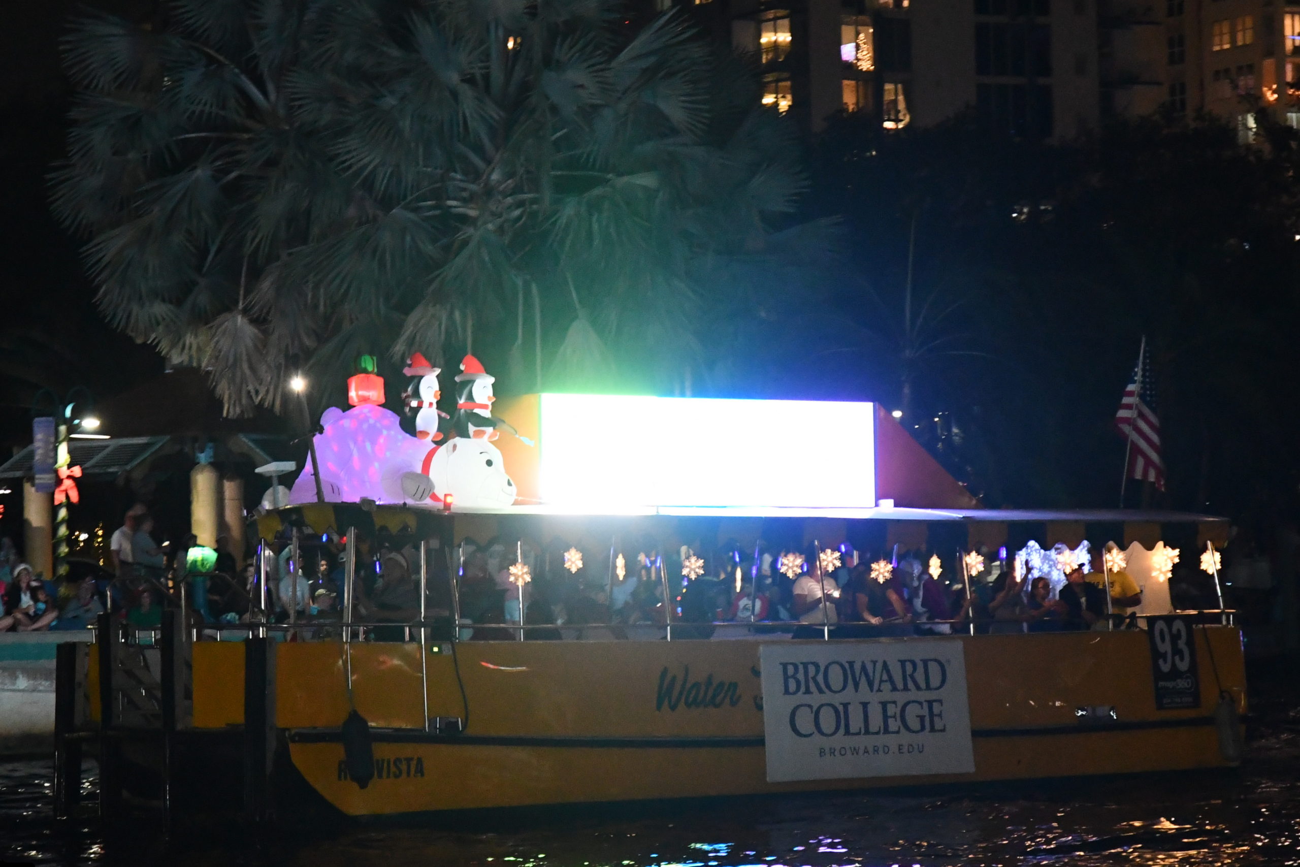 Broward College aboard Water Taxi Rio Vista, boat number 93 in the 2022 Winterfest Boat Parade