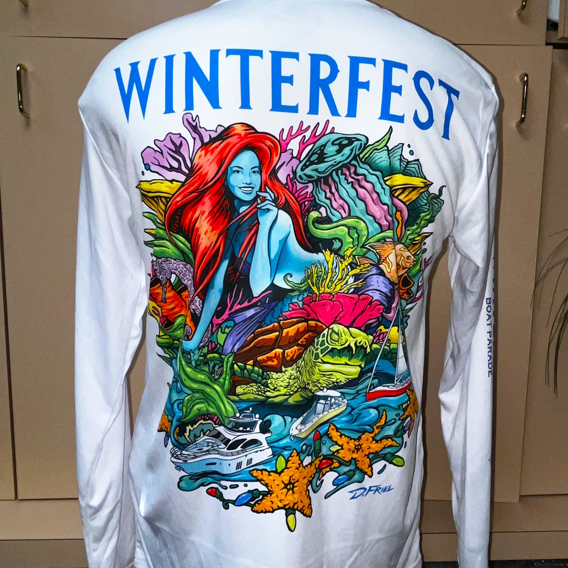 https://winterfestparade.com/wp-content/uploads/2023/08/2022-D.-Friel-Winterfest-Shirt-BACK-White-NewLogo_1920x1920.jpg